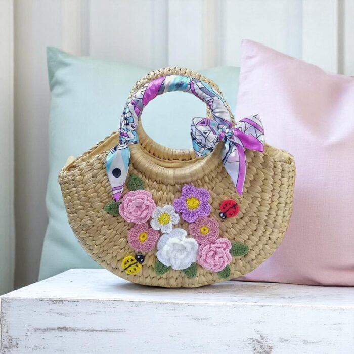Mini half-moon straw purse with crochet flower embroidery and scarf-wrapped round handles