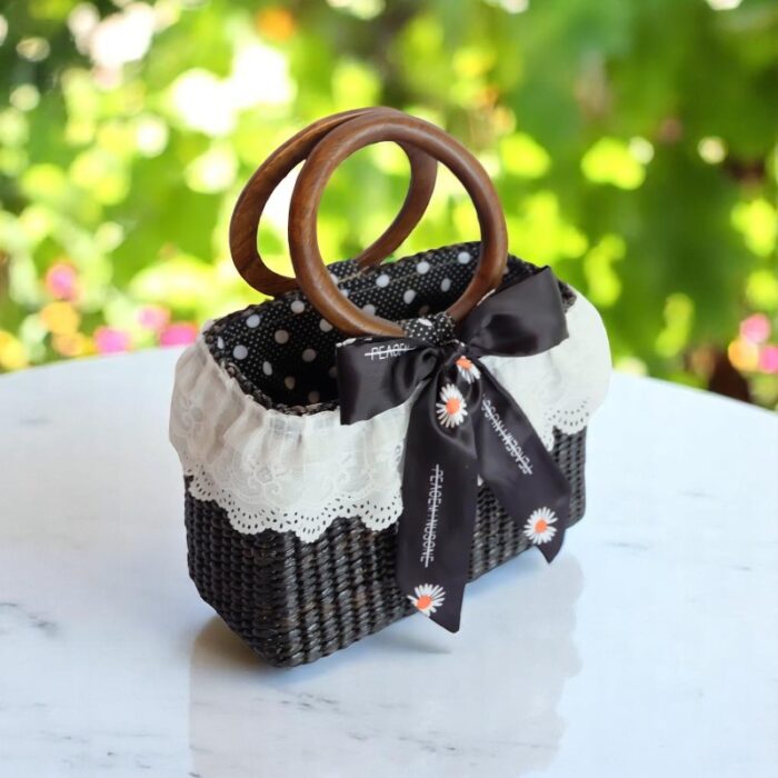 Black straw purse with wooden handles and lace trim