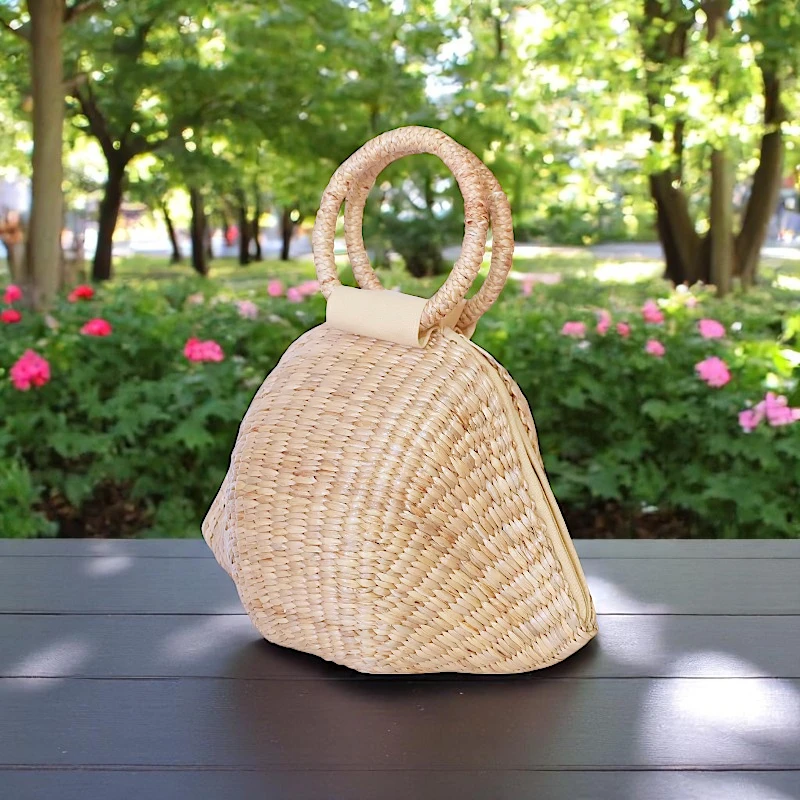 Structured straw designer handbag with round woven handles