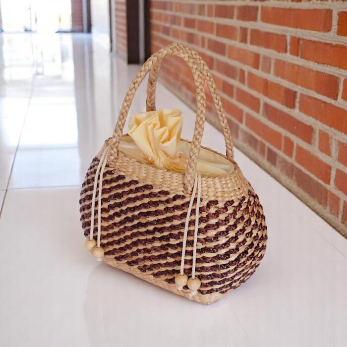 Thidarat Straw Spiral Weave Bucket Bag – two-tone rounded bucket bag with rope handles and drawstring top
