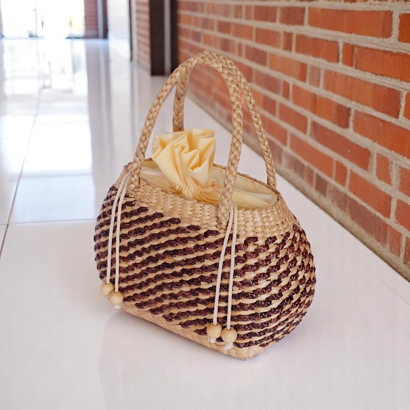 Thidarat Straw Spiral Weave Bucket Bag – two-tone rounded bucket bag with rope handles and drawstring top